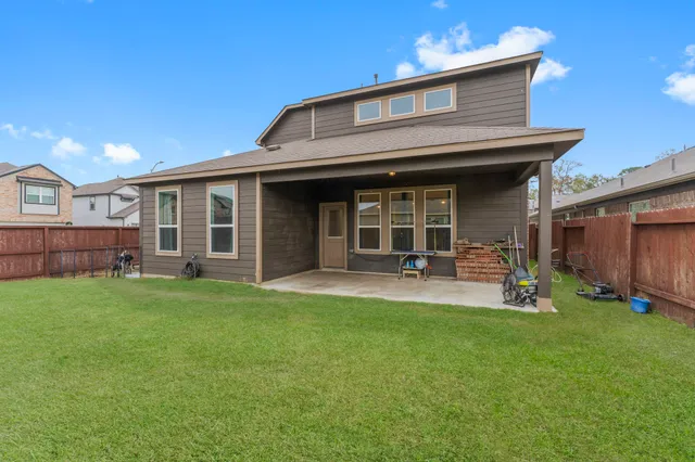 a view of a house with backyard porch and sitting area