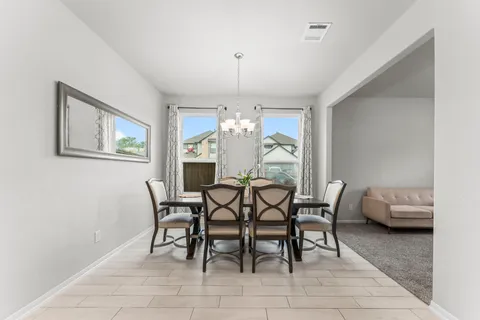 a dining room with furniture and window