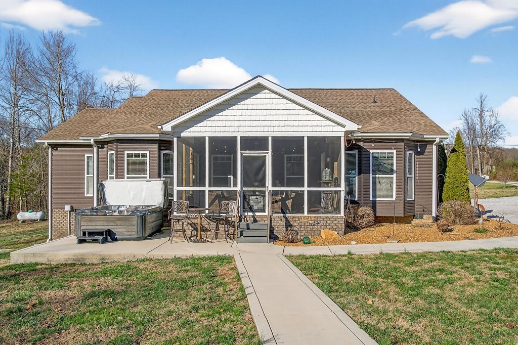 6081 Buck Mountain Road Cookeville, TN 38506 - Photo 51 of 78 a front view of a house with a garden and sitting area