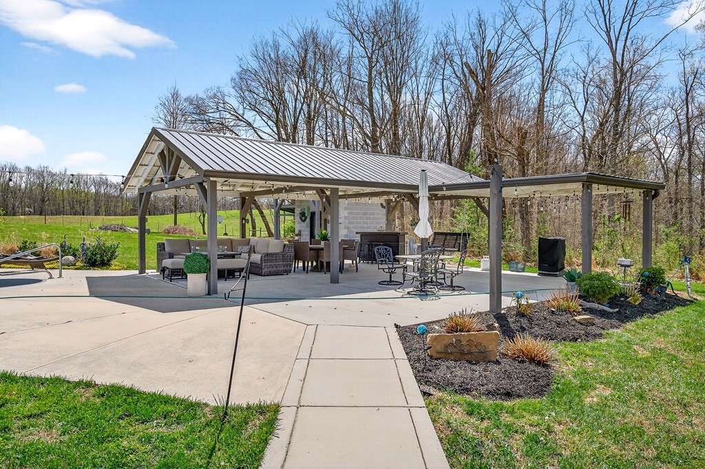 6081 Buck Mountain Road Cookeville, TN 38506 - Photo 74 of 78 a view of a patio with a table and chairs under an umbrella