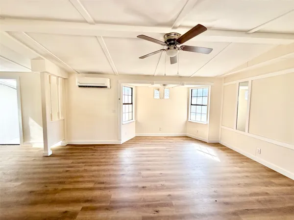 a large kitchen with stainless steel appliances granite countertop a lot of counter space and wooden floors