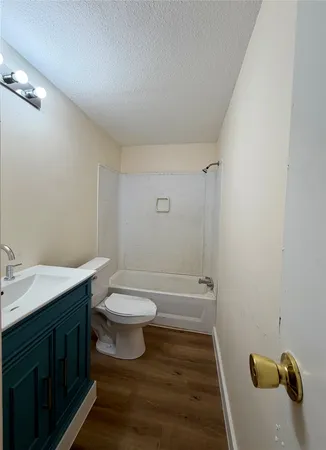 a view of room with wooden floor and cabinets