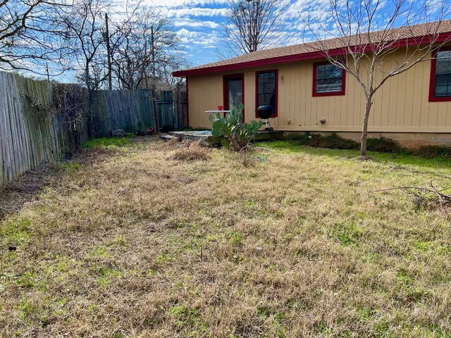 a view of front of house with wooden fence