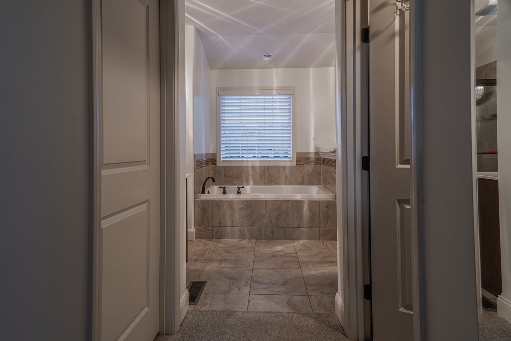 5107 Longfield Road Bloomington, IL 61705 - Photo 13 of 25 a bathroom with a bathtub