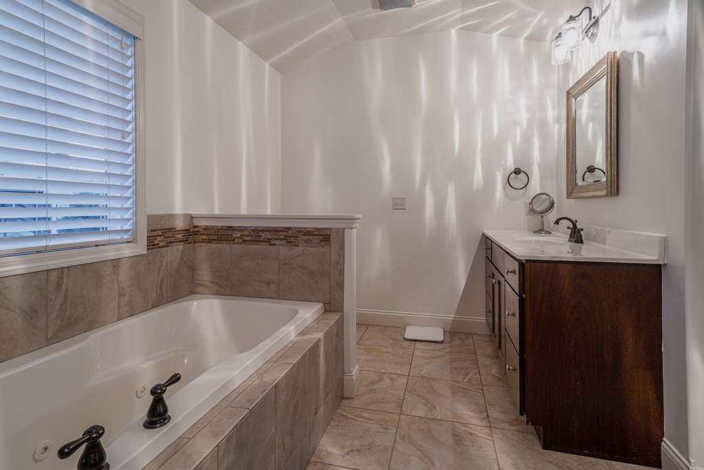 5107 Longfield Road Bloomington, IL 61705 - Photo 15 of 25 a bathroom with a bathtub and sink