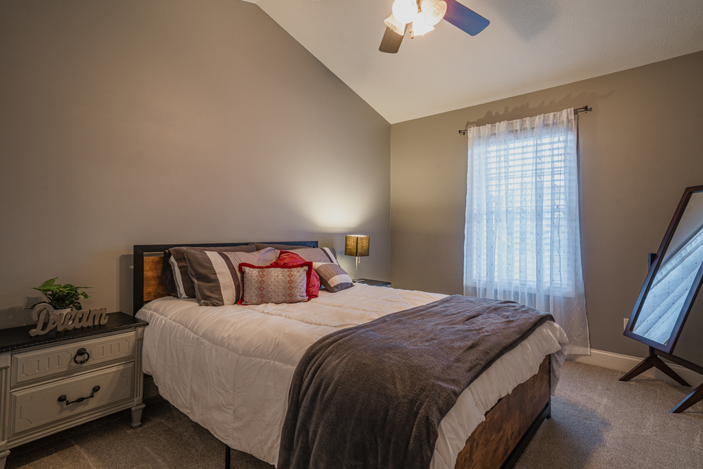 5107 Longfield Road Bloomington, IL 61705 - Photo 16 of 25 a bedroom with a bed and a chandelier