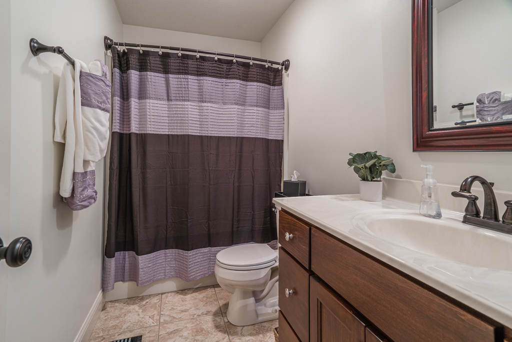 5107 Longfield Road Bloomington, IL 61705 - Photo 17 of 25 a bathroom with a sink toilet and shower