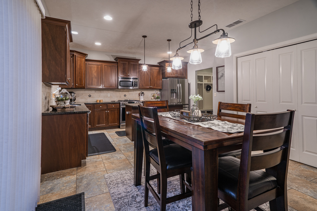 5107 Longfield Road Bloomington, IL 61705 - Photo 10 of 25 a view of a dining room and kitchen with a table and chairs