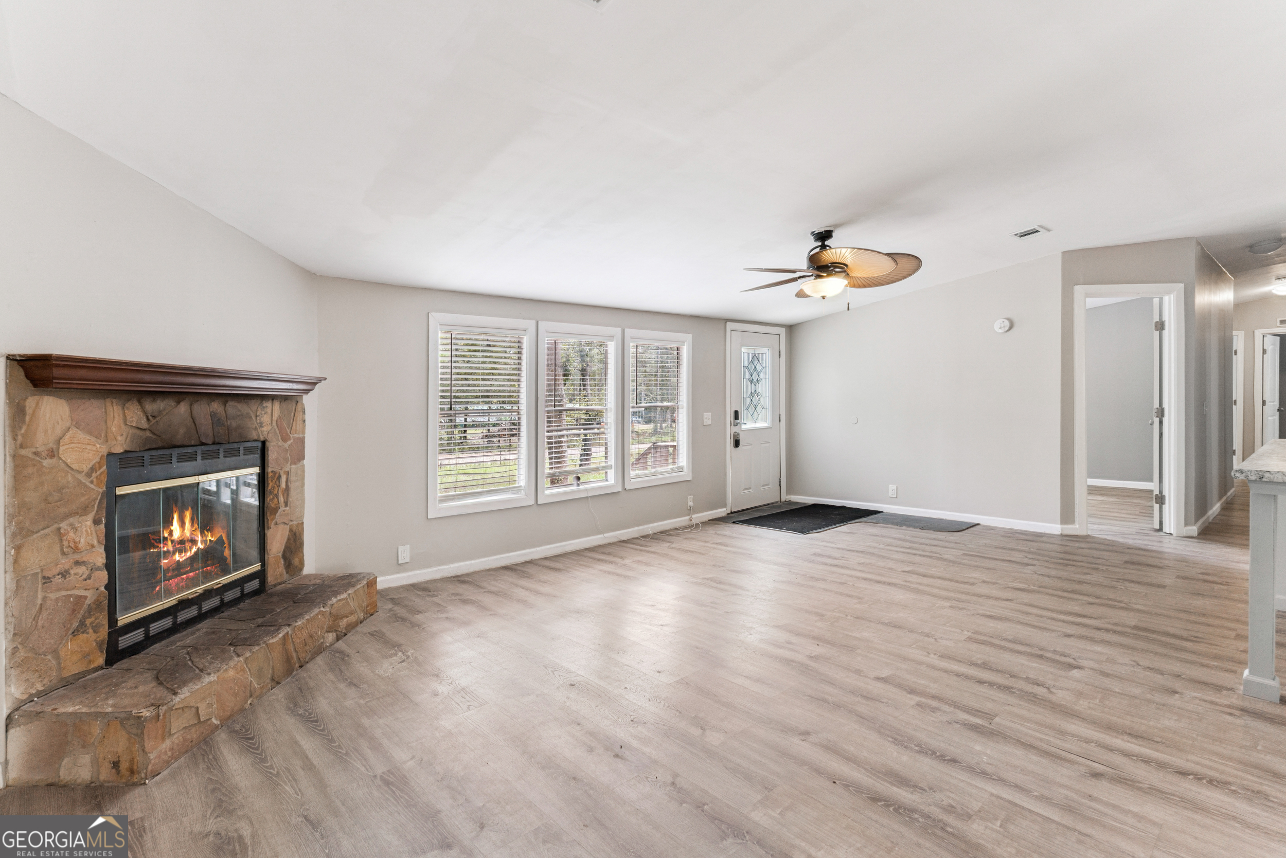68 Amber Drive Waverly, GA 31565 - Photo 12 of 39 a view of an empty room with a fireplace and a window