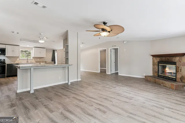 a view of a kitchen and an empty room