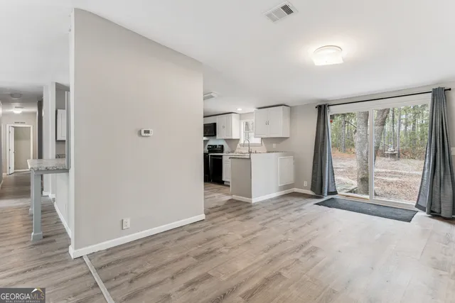 a view of a kitchen with a stove cabinets and a wooden floor