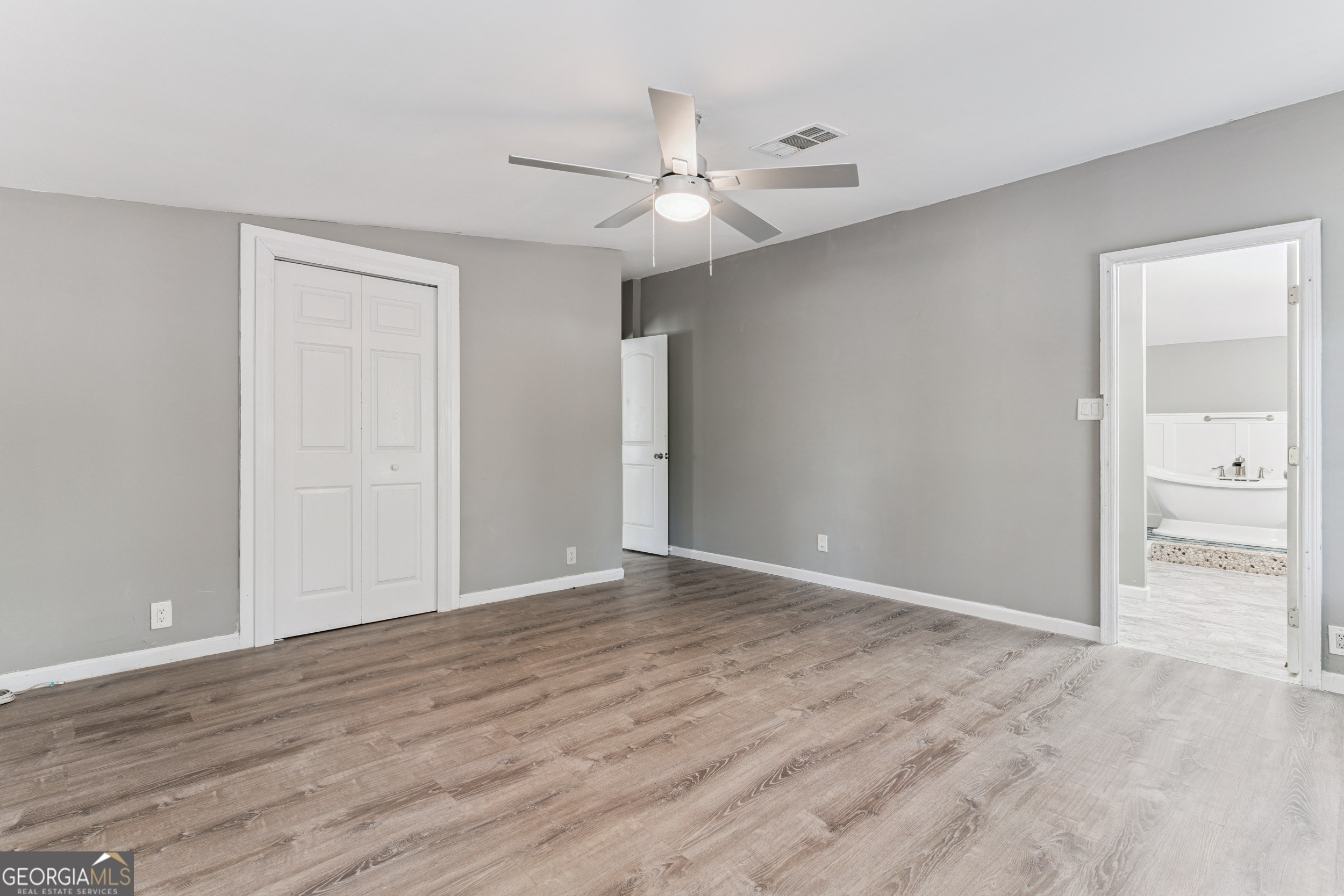 68 Amber Drive Waverly, GA 31565 - Photo 26 of 39 a view of an empty room with wooden floor