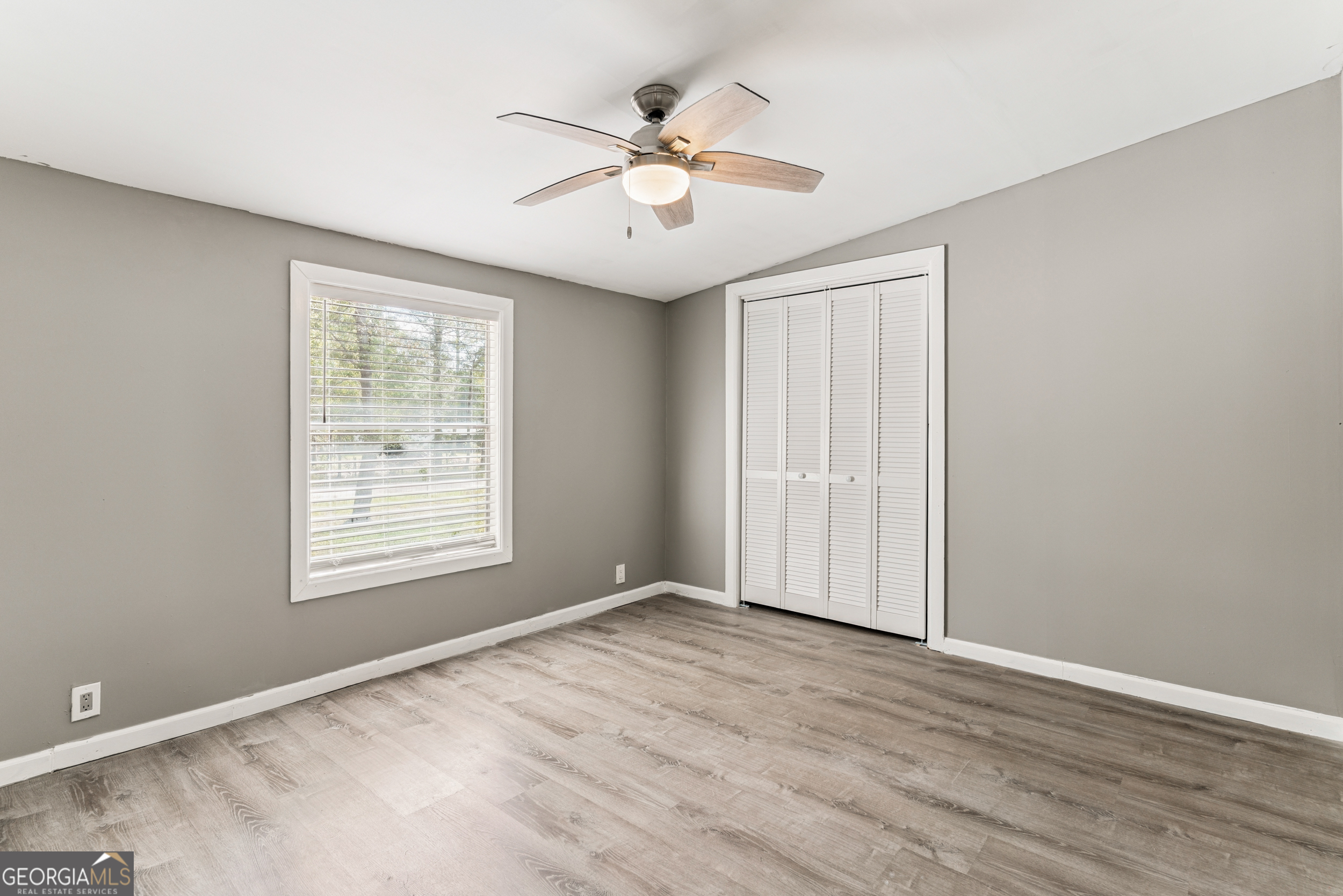 68 Amber Drive Waverly, GA 31565 - Photo 32 of 39 an empty room with wooden floor and windows