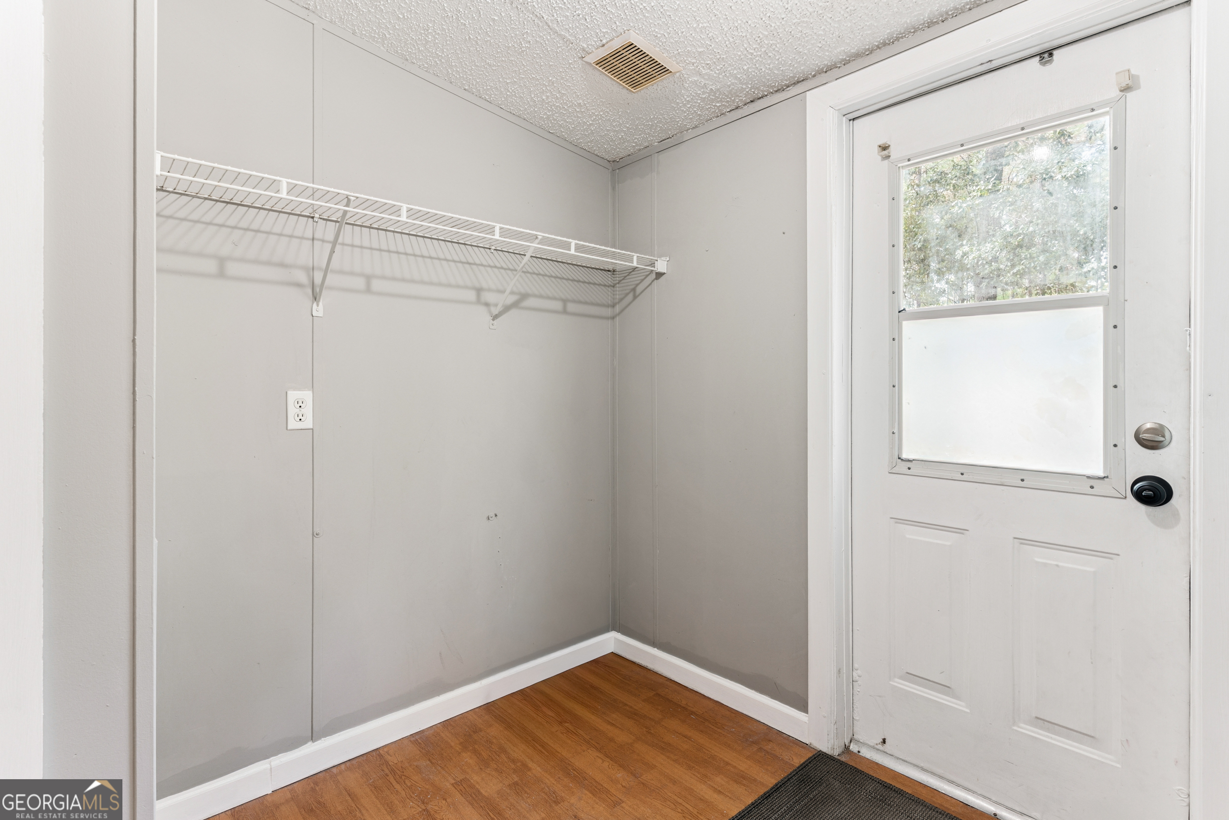 68 Amber Drive Waverly, GA 31565 - Photo 37 of 39 a view of a room with wooden floor and small window