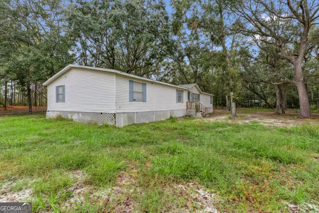 a white house that has a tree in front of it