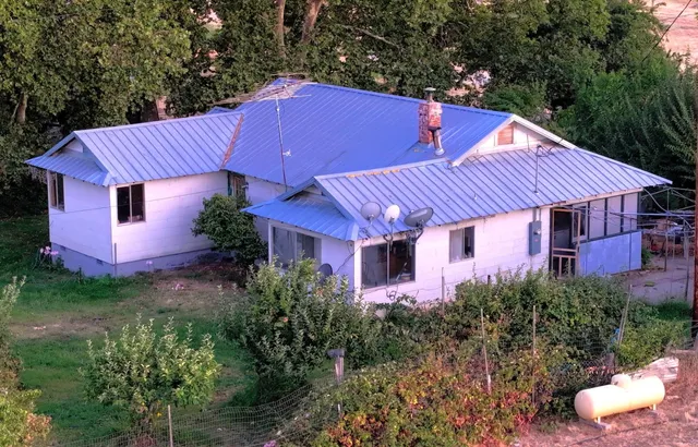 a view of a house with pool and a yard