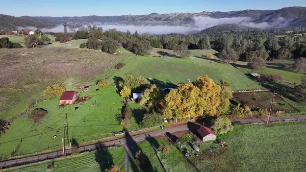 a backyard of a house with barbeque oven table and chairs