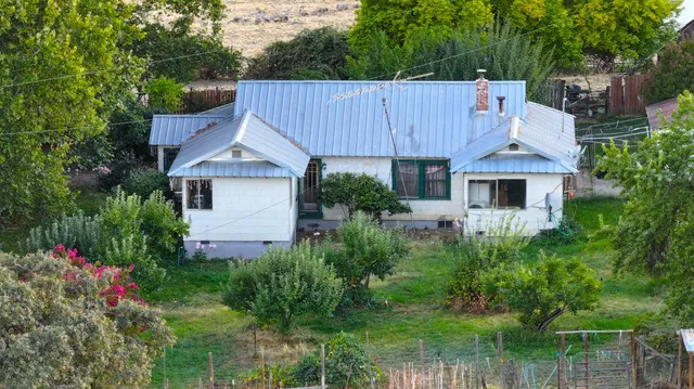 a white and red umbrella sitting in front of a window