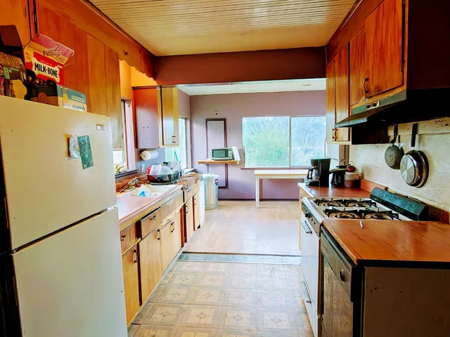 a view of a dining room with furniture and a chandelier