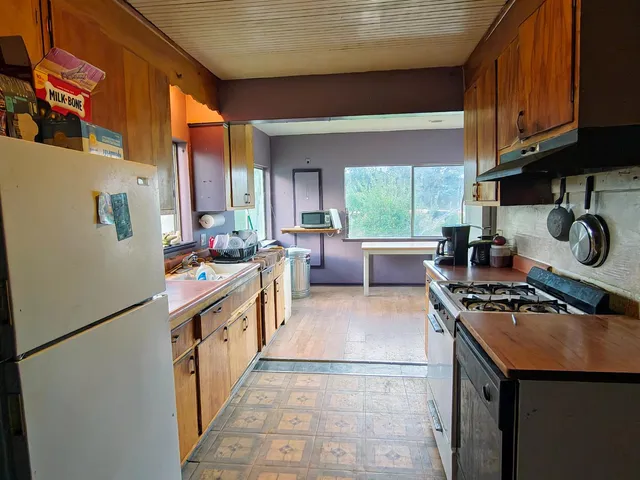 a view of living room with furniture and wooden floor