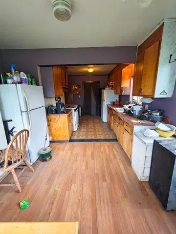 a room with wooden floor and furniture