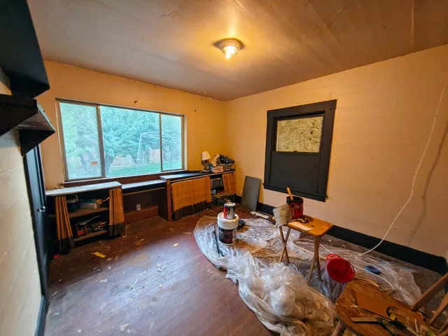 a view of dirt field with trees in background