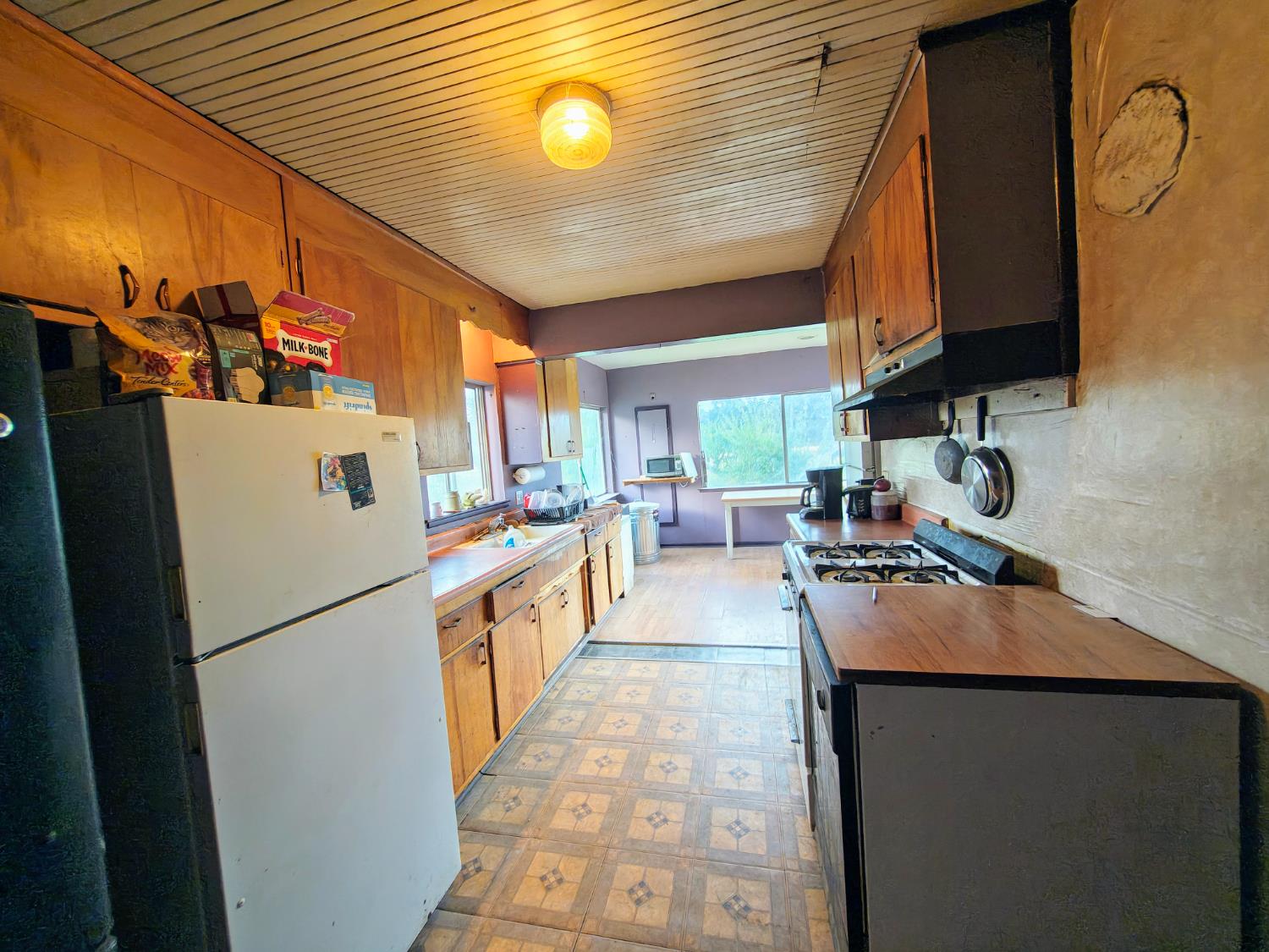 5661 Thompson Hill Road Placerville, CA 95667 - Photo 37 of 68 a kitchen with stainless steel appliances granite countertop a refrigerator a stove and a sink with wooden floor