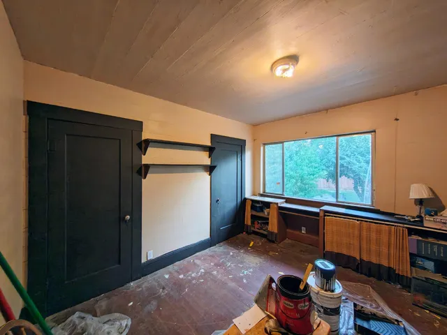 a view of a city street with a car parked on the road