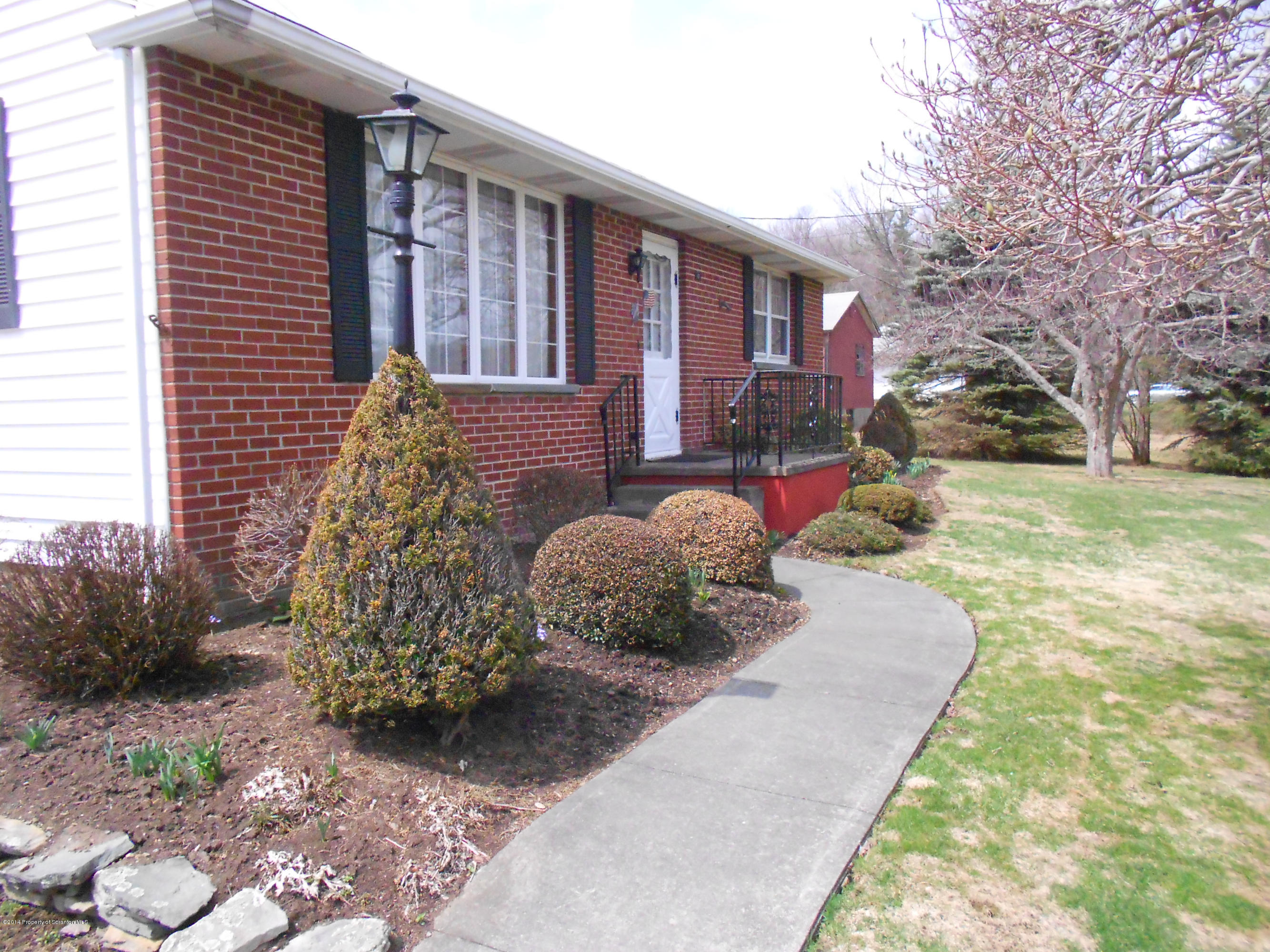 17 T Rte 318 Moscow, PA 18444 - Photo 2 of 30 a front view of a house with garden