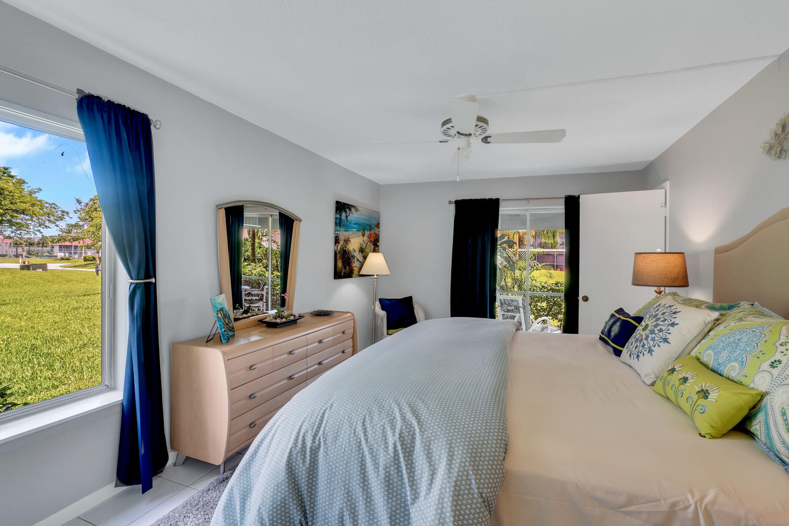 6544 Chasewood Drive, Unit D Jupiter, FL 33458 - Photo 11 of 16 a bedroom with a bed and large windows