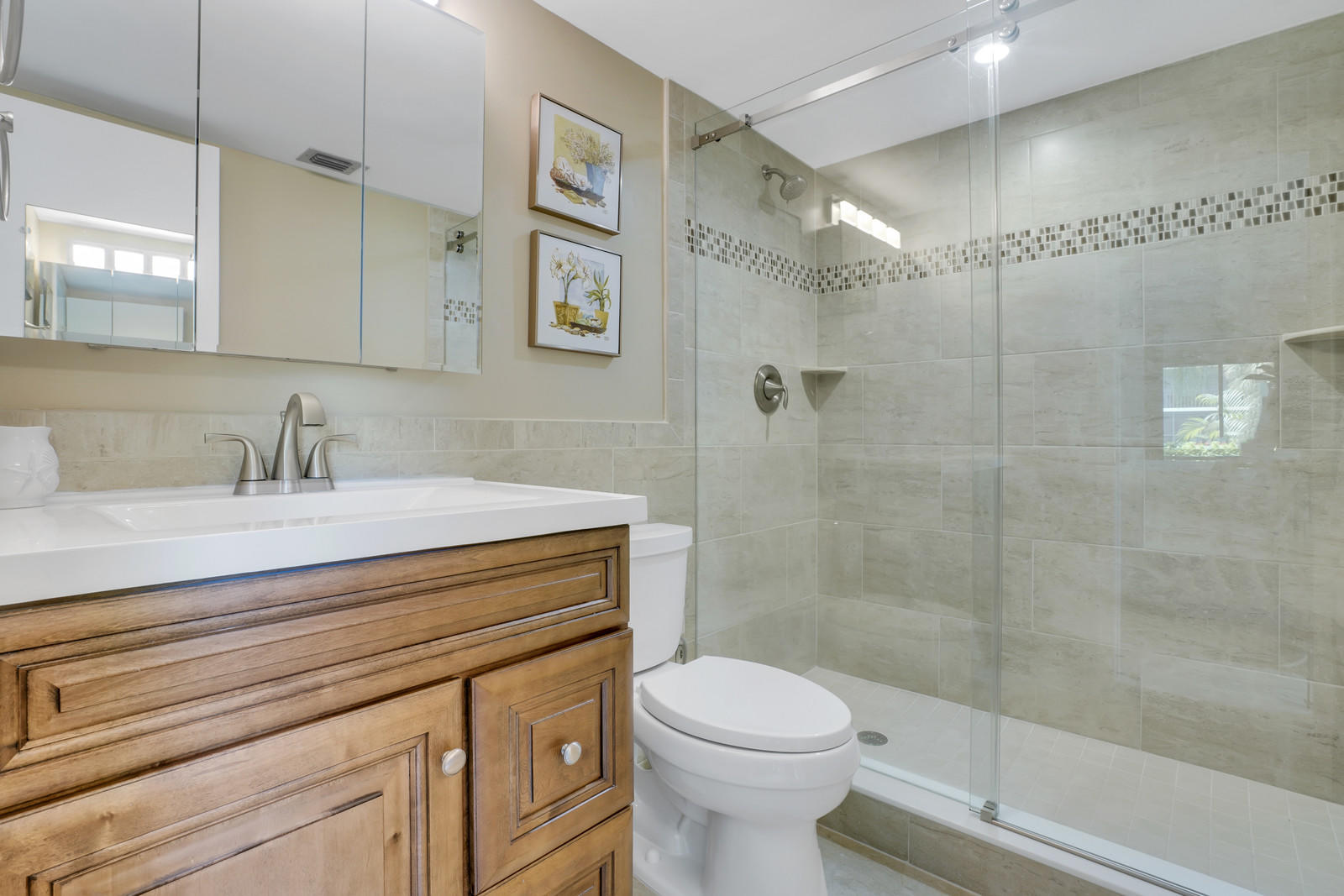 6544 Chasewood Drive, Unit D Jupiter, FL 33458 - Photo 12 of 16 a bathroom with a sink a toilet and shower