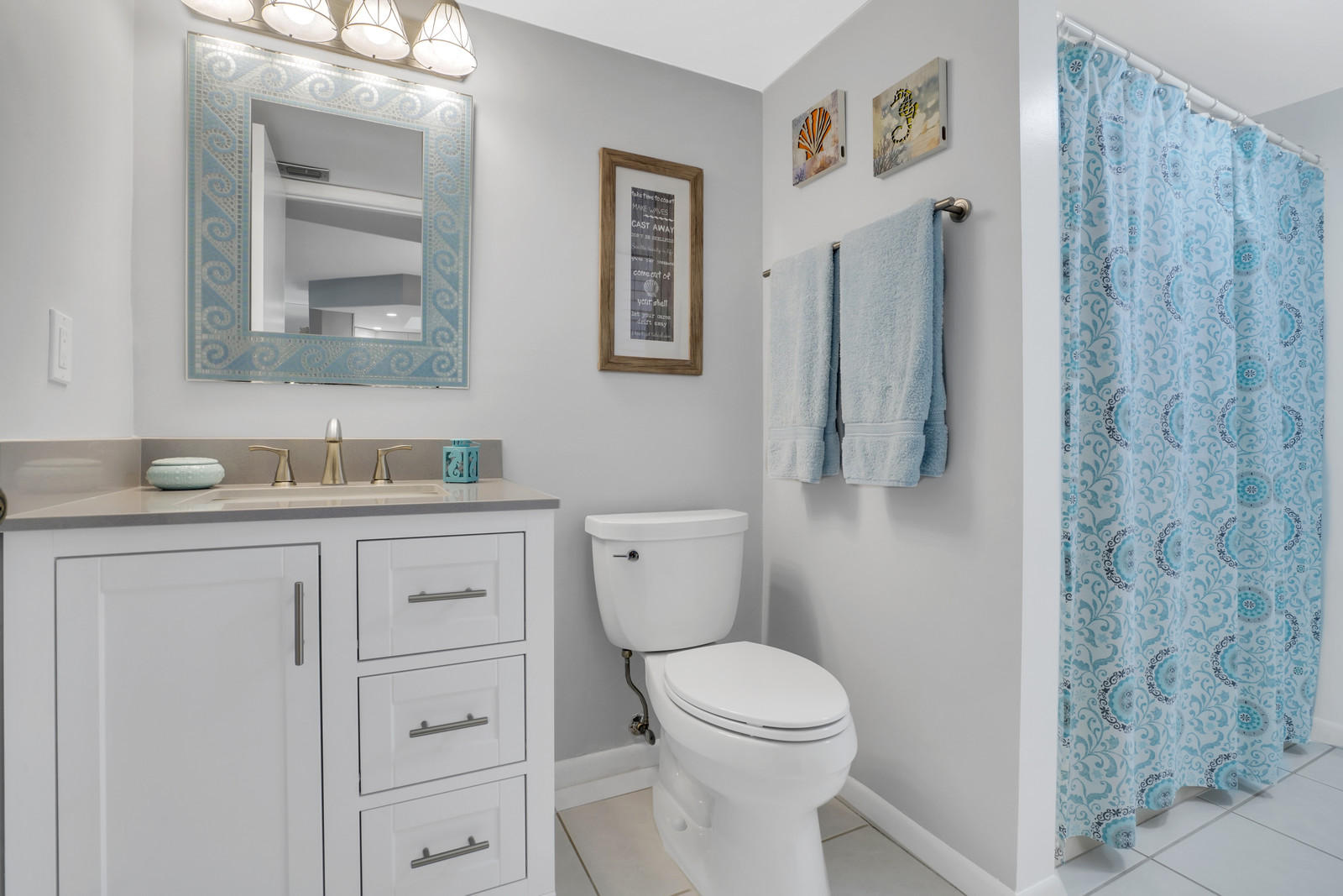 6544 Chasewood Drive, Unit D Jupiter, FL 33458 - Photo 14 of 16 a bathroom with a granite countertop toilet sink and mirror