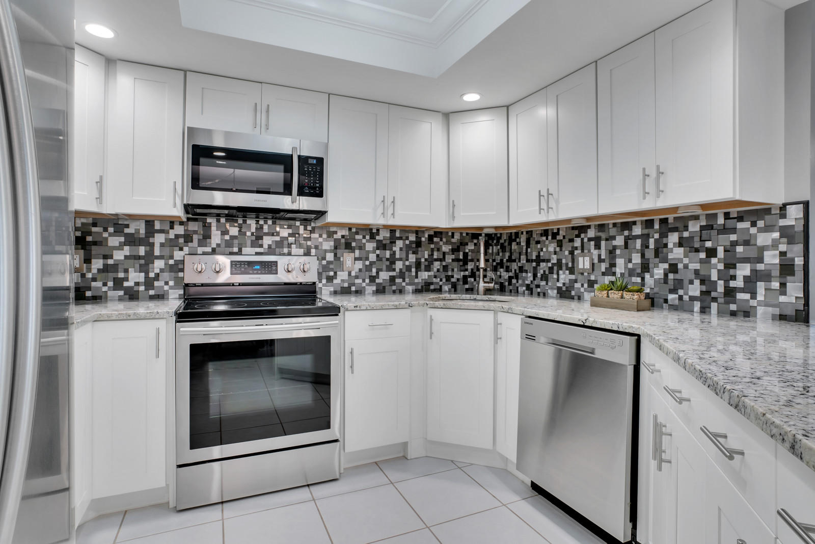 6544 Chasewood Drive, Unit D Jupiter, FL 33458 - Photo 3 of 16 a kitchen with white cabinets appliances and sink