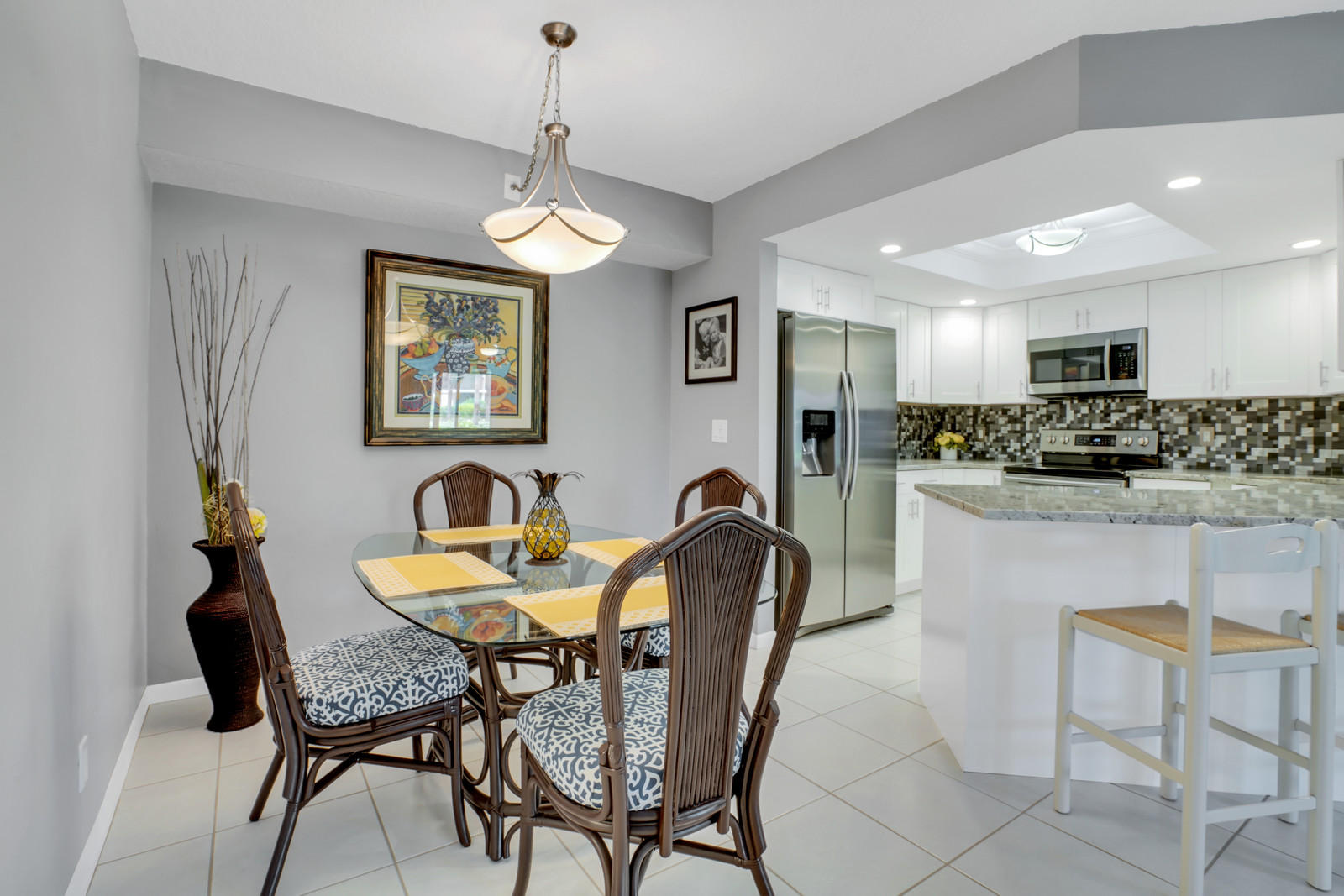 6544 Chasewood Drive, Unit D Jupiter, FL 33458 - Photo 5 of 16 a view of a dining room with furniture and a chandelier