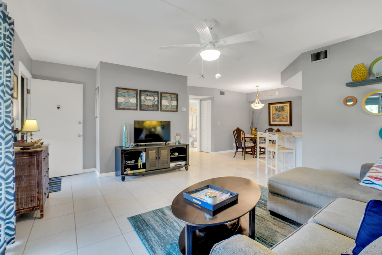 6544 Chasewood Drive, Unit D Jupiter, FL 33458 - Photo 7 of 16 a living room with furniture and a flat screen tv