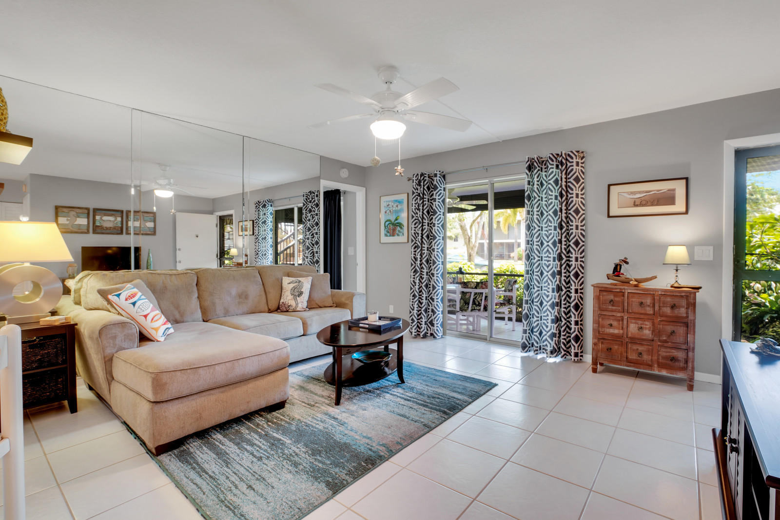 6544 Chasewood Drive, Unit D Jupiter, FL 33458 - Photo 8 of 16 a living room with furniture and a large window