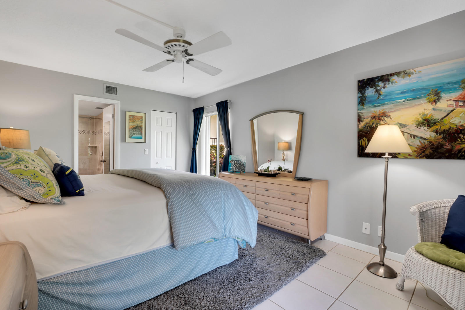 6544 Chasewood Drive, Unit D Jupiter, FL 33458 - Photo 9 of 16 a bedroom with a bed and a dresser with mirror