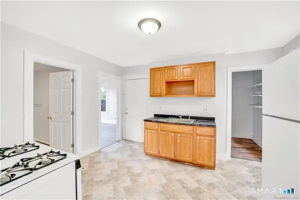 a kitchen with stainless steel appliances granite countertop a stove and a refrigerator
