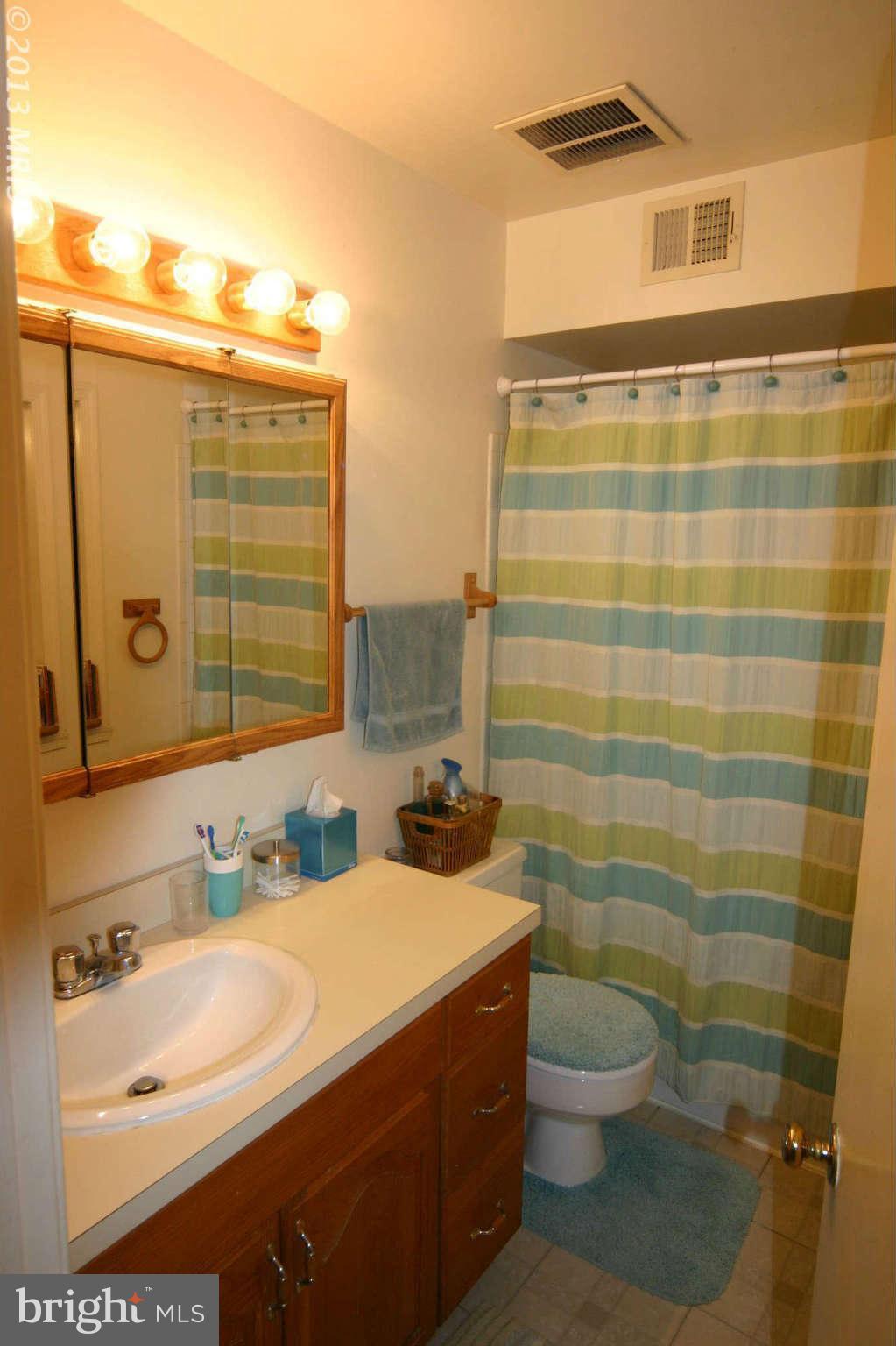 5915 Kingsford Road, Unit 365 Springfield, VA 22152 - Photo 12 of 17 a bathroom with a sink a toilet and shower