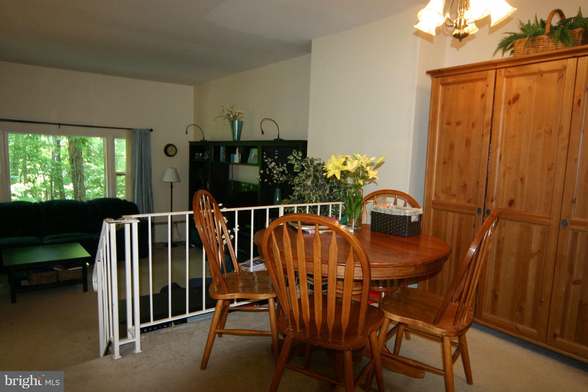 5915 Kingsford Road, Unit 365 Springfield, VA 22152 - Photo 3 of 17 a view of a dining room with furniture window and outside view