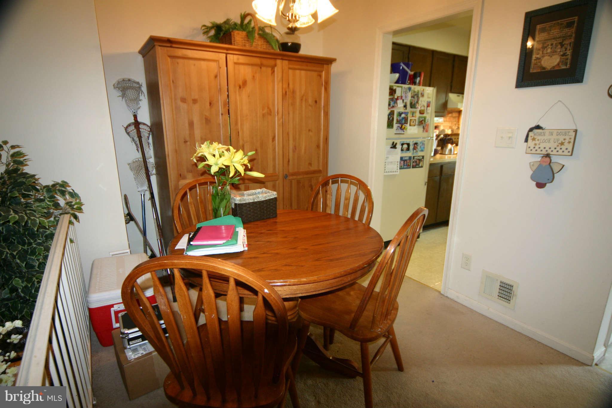 5915 Kingsford Road, Unit 365 Springfield, VA 22152 - Photo 4 of 17 a view of a dining room with furniture and chandelier