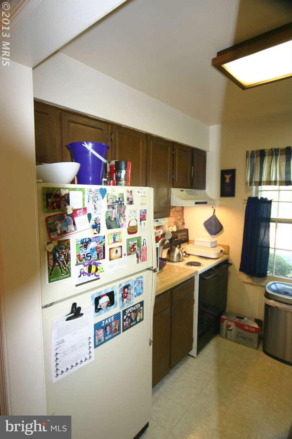 5915 Kingsford Road, Unit 365 Springfield, VA 22152 - Photo 7 of 17 a kitchen with stainless steel appliances granite countertop a sink and a stove