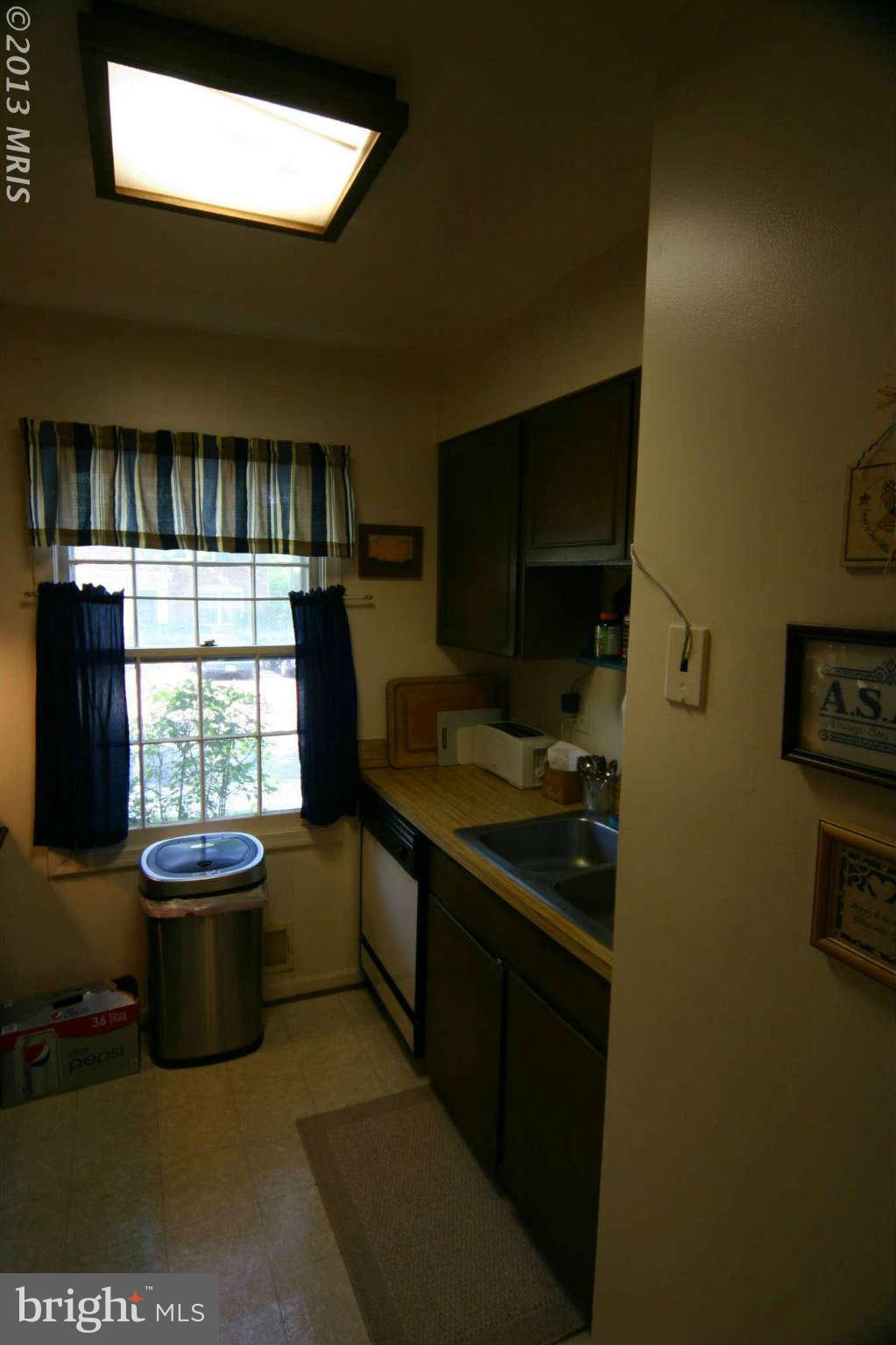 5915 Kingsford Road, Unit 365 Springfield, VA 22152 - Photo 8 of 17 a kitchen with a sink appliances and cabinets