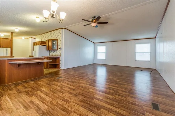 a kitchen with a refrigerator sink and cabinets