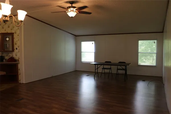 a large kitchen with kitchen island a large counter space wooden floor and stainless steel appliances
