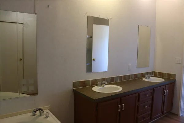 a bathroom with a tub and shower