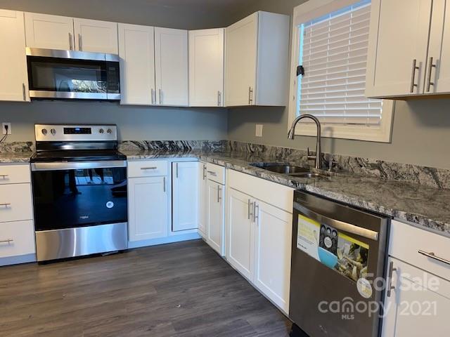 1599 Springdale Road Lancaster, SC 29720 - Photo 11 of 28 a kitchen with stainless steel appliances granite countertop a stove a sink and a microwave