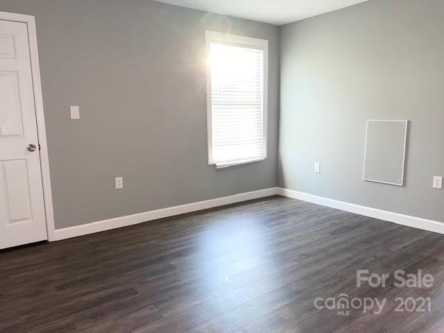 1599 Springdale Road Lancaster, SC 29720 - Photo 12 of 28 an empty room with wooden floor and windows