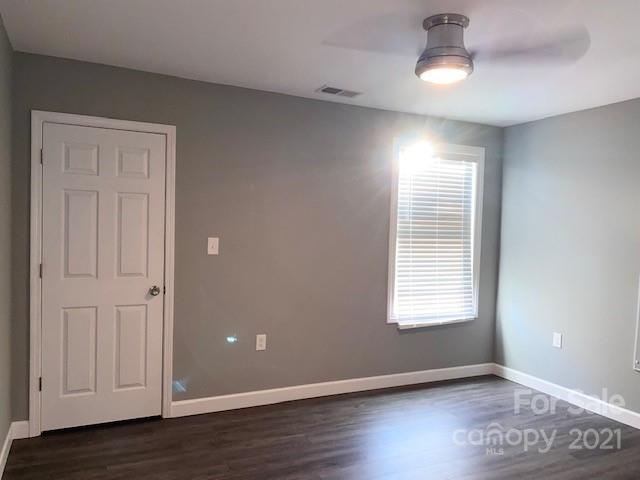 1599 Springdale Road Lancaster, SC 29720 - Photo 13 of 28 an empty room with wooden floor cabinet and windows