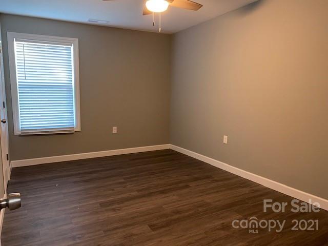 1599 Springdale Road Lancaster, SC 29720 - Photo 18 of 28 a view of an empty room with wooden floor and a window